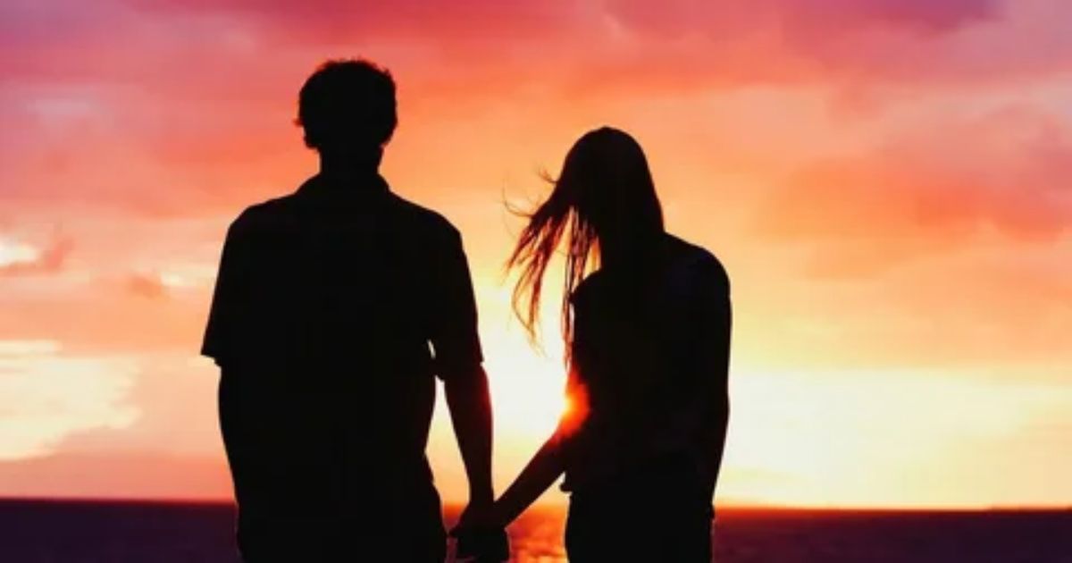 couple holding hands at sunset — long distance love poems