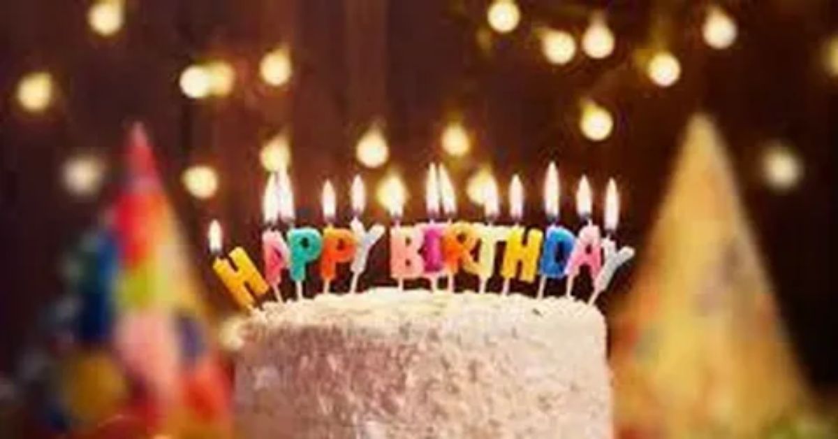 Birthday poem beside a birthday cake with lit candles