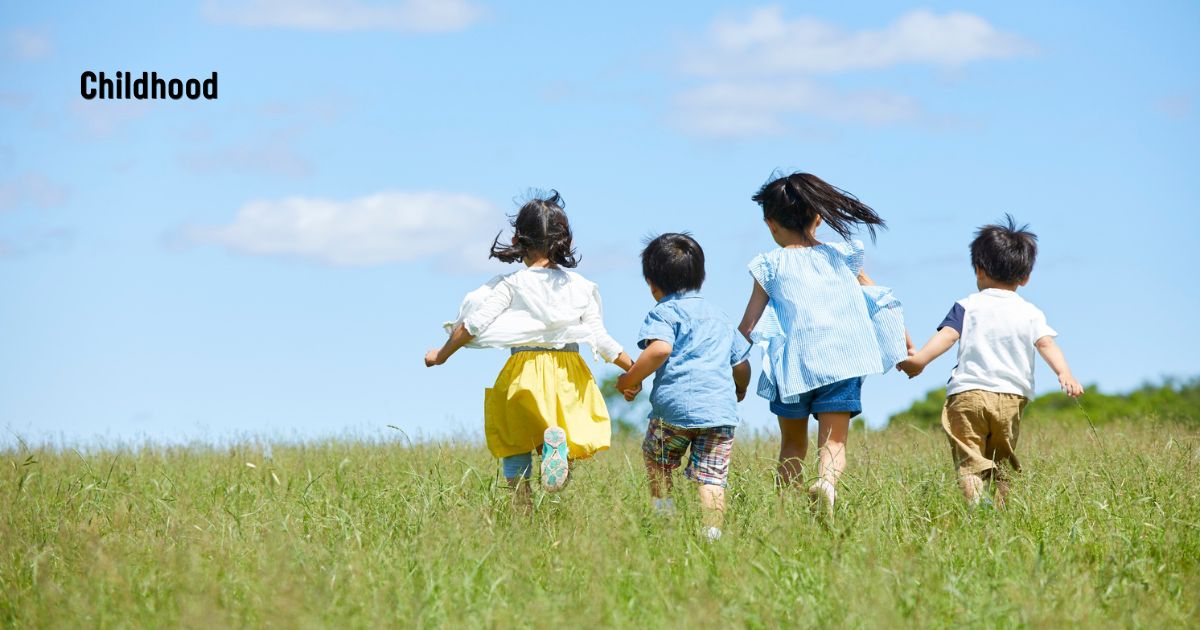 Children running through a grassy field — justify the title of the poem Childhood.