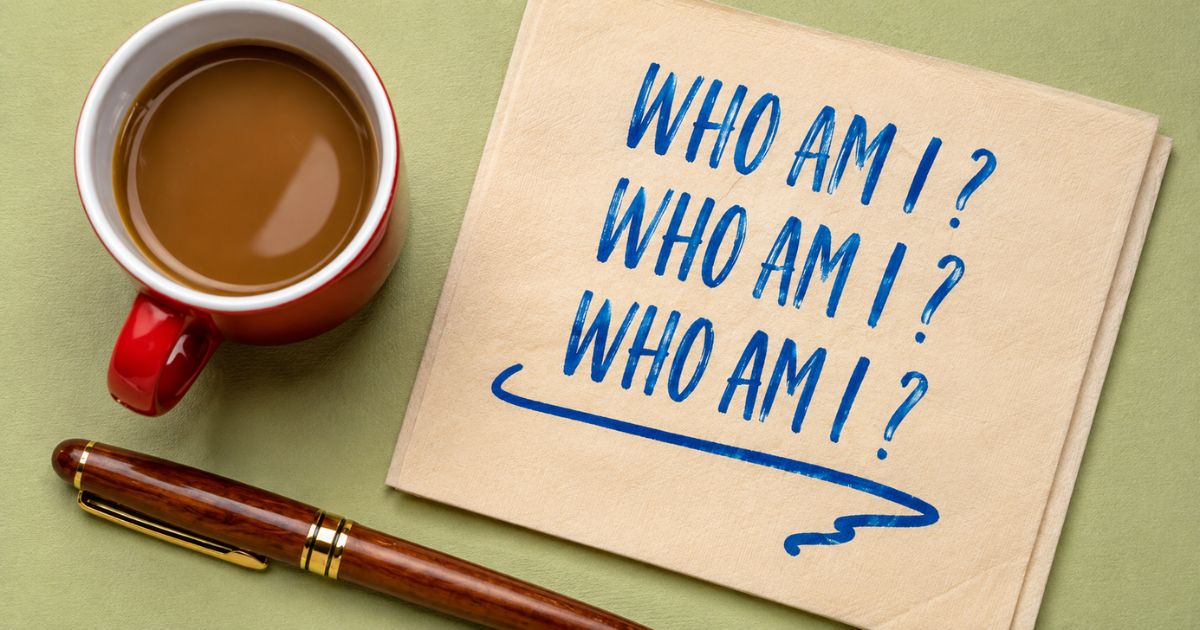 Who am i poem written on napkin beside coffee cup and pen, self-reflection concept.